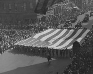 A military parade with crowds of excited spectators along 5th Avenue, in celebration of Armistice day and peace in Europe following World War One, New York, 1918. (Photo by Paul Thompson/FPG/Getty Images)
